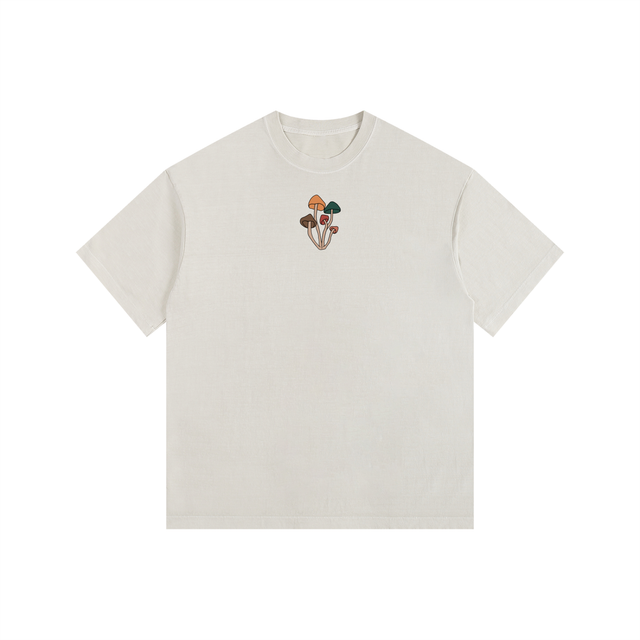 Garment-washed heavyweight cotton tee from Maya Mushroom. Full-color mushroom cluster on the chest, clean back. Oversized drop shoulder in natural cream. Simple and built to last.