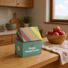 ShroomBag Mushroom Grow Kit on a wooden kitchen counter beside a mushroom-branded towel and a bowl of apples