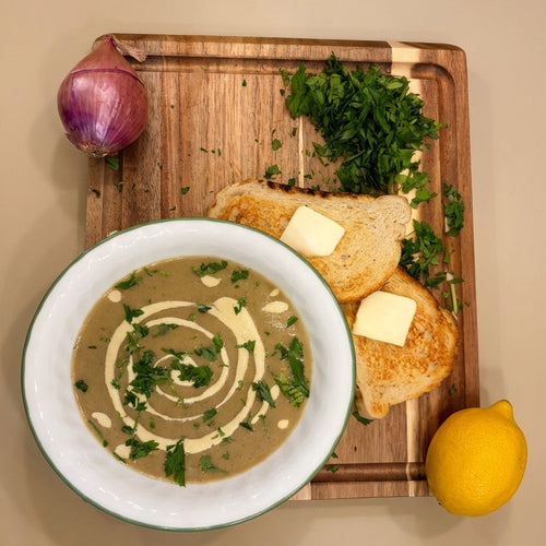 Promotional image for Maya Mushroom ShroomBag Grow Kit with mushroom soup and bread on a wooden board.